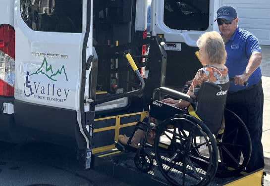 woman in wheelchair putting on transport